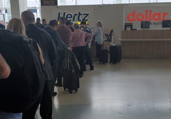 Hmmm....I'm getting a Dollar rental, but standing in a Hertz line with one person at the counter.  Nice