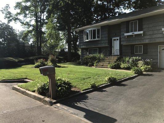 Trimmed bushes and freshly cut lawn for a customer in kings park.