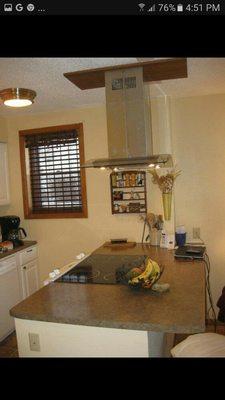 Removed wall and installed pass-through countertop, stovetop and chimney vent