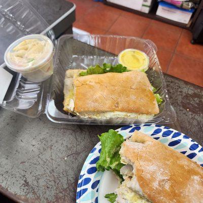 Chicken avocado sandwich with mozzarella, pasta salad, and a honey mustard sauce (maybe?)