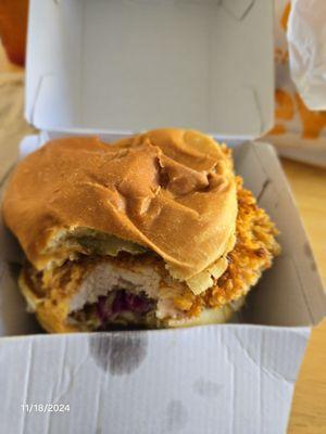 One bite taken out of this huge spicy chicken sandwich!