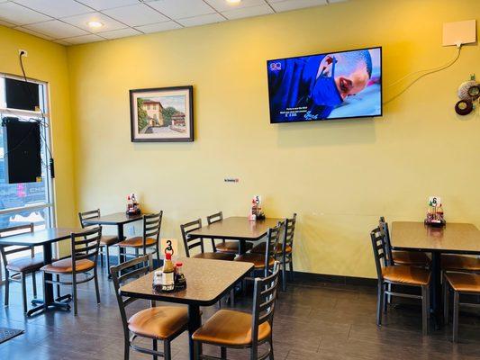 Dining area with flat screen monitor mounted on wall