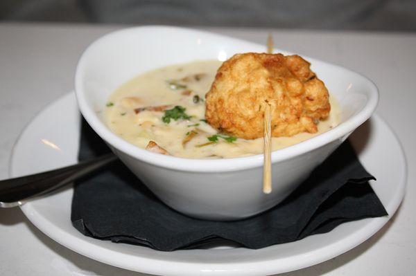 The Clam Chowder is made with clams, bacon and comes with a Sea Clam Fritter on top.