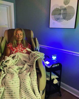 A client enjoying a Nanovi session in our Brio positive posture 4D massage chair