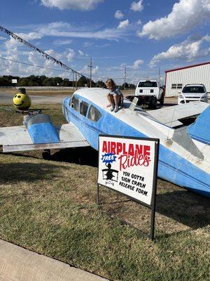 The airplane in the parking lot.