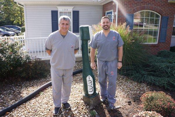 Dr Green and Dr Pawlecki standing with the large toothbrush in front of our Delaware, Ohio Dental Office