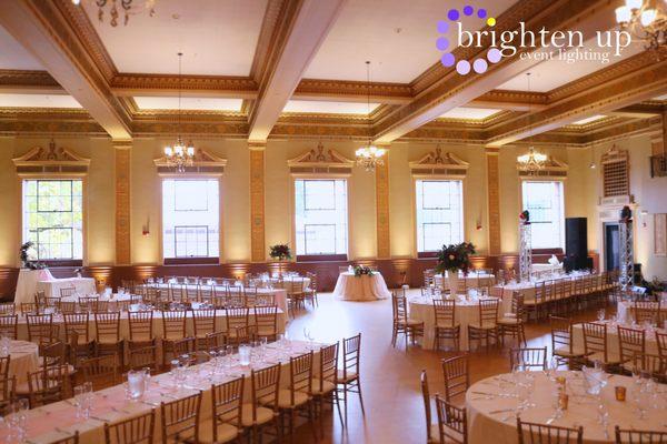 Soft Gold Uplighting at the beautiful Elks Tower Event Center. Uplighting by www.brightenuplighting.com