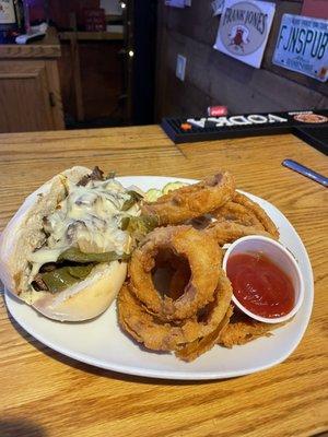 Steak sub with onion rings.