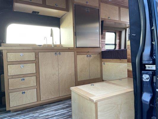 The cabinets are beautiful and Jimmy created plenty of storage.  The cabinet door to the garage drops down to create a step.