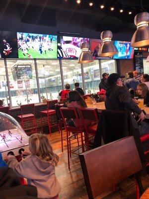 Inside of Rookies pub. From pub window, you can see the inside of the ice rink.