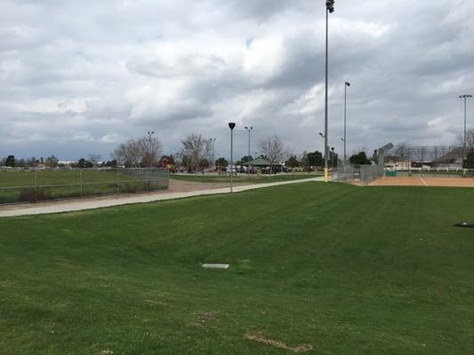 Parking lot next to toddler play area and covered picnic area