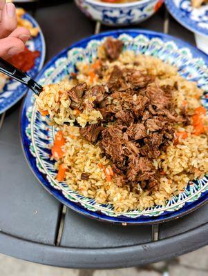 Beef rice Pilaf-Tender chunks of meat, fluffy rice, carrots, onions and cumin cooked in a seasoned broth. Served with salad.