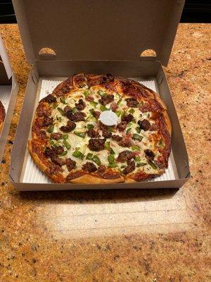 Deluxe pizza with homemade meatballs, onion, sausage and green peppers