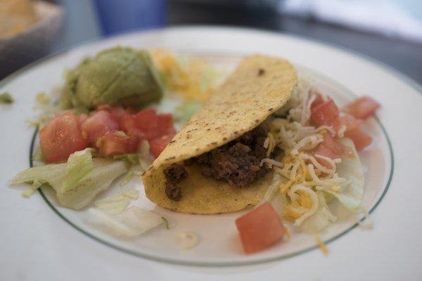 First plate of combo #2 is a crispy taco, tomatos, and guacamole