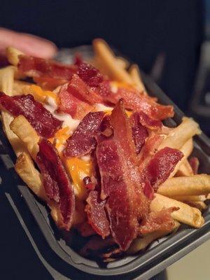 'Baconator fries', natural-cut fries topped with warm cheddar cheese sauce, pieces of applewood-smoked bacon, and shredded cheddar cheese.