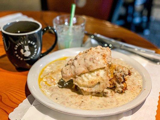 Biscuits and Gravy with fried Chicken, cheddar cheese and a fried egg