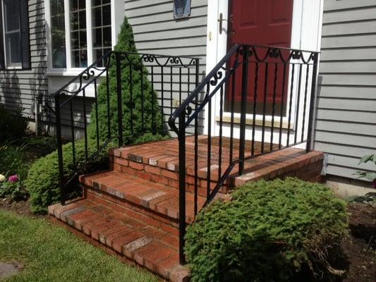 Black galvanized wrought iron railing with scrolls