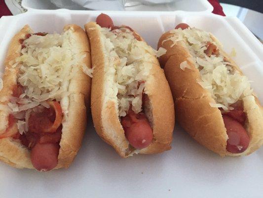 A trio of sautéed onions and kraut dogs