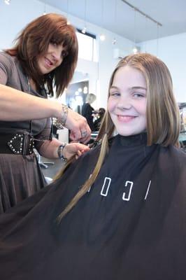 Gail Brightman cutting Erin's hair to help children with cancer fight their battles without feeling self-conscious! Thanks Erin!