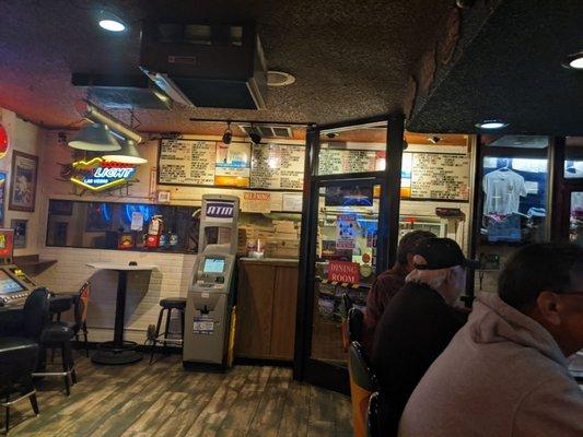 bar area and menu on the wall.