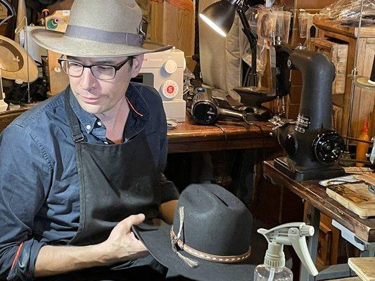 Pascal finishing my custom cowboy hat.