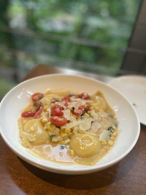 Ravioli with corn and ricotta, tomatoes, Parmesan, pancetta