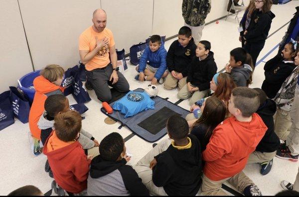 Kids learn hands-only CPR as a part of The Crumley Roberts Kids Zone Program.