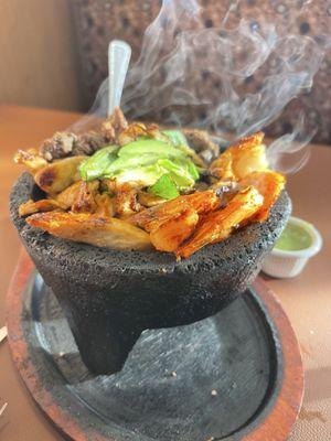 El molcajete served by Gustavo. Food is amazing, and must try the Margarita.