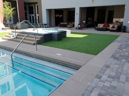 Artificial turf around outdoor hot tub and pool in Denver.