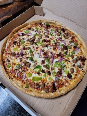 Sausage, bacon, green pepper and onion pizza.