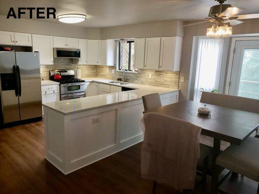 Cabinets resurfaces, new countertop, backsplash, floor, lighting and paint.