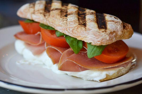 Panini with prosciutto di parma, fresh mozzarella, tomatoes and basil