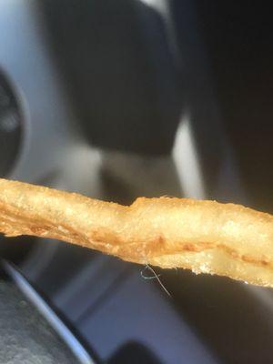 Hair on fries. Sloppy packaging. Not appetizing.