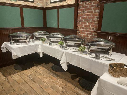 Food set up buffet style across from the bar