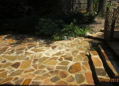 Natural stone patio installed by LandscapeOne.