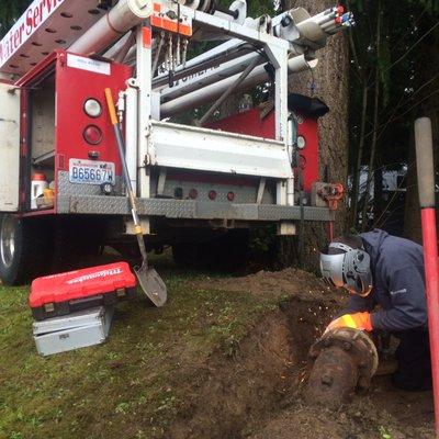 Technician removing flange on 6 inch water main