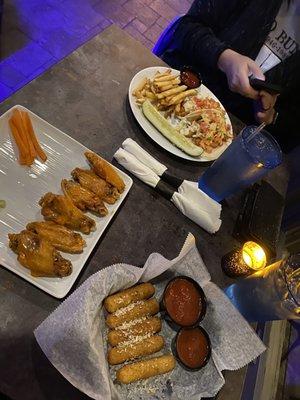 Wings, mozzarella sticks, and fried fish tacos