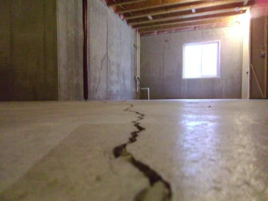 Serious cracking in basement concrete floor on new construction home in Fortville Indiana. New homes need inspected too.