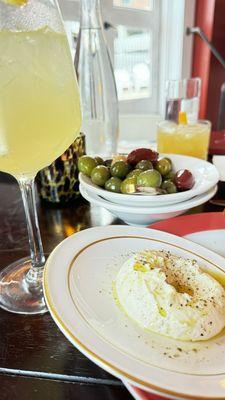 Arancello Spritz, marinated olives, and whipped ricotta with rosemary focaccia.