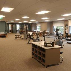 Physical Therapy area in the same office location, with large open treatment space and private evaluation and treatment rooms.