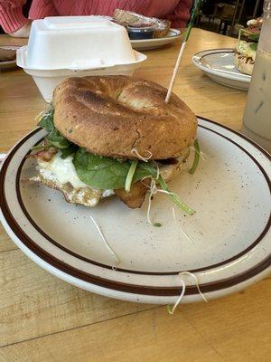 Bagel Sandwich: Gluten Bagel, provolone, eggs, bacon, spinach, sprouts, and pesto