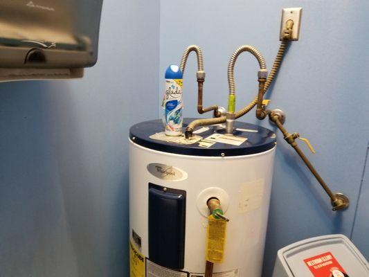 Aerosol can on top of water heater. Fire hazard.