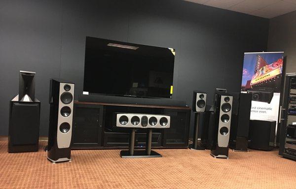 Channel's showroom area with high-end audio electronics and speakers in a Dolby Atmos configuration.