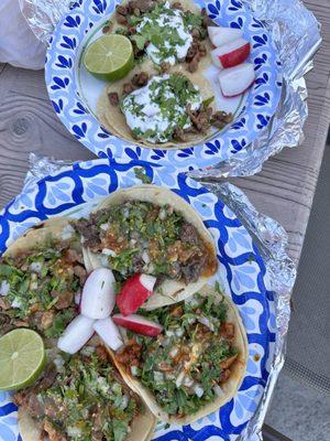 Birria, carne asada, cabeza and al pastor tacos. 2 of them with sour cream for the kiddo.