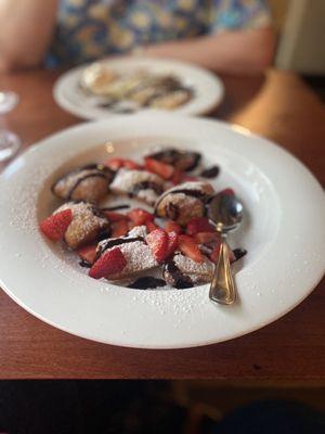 Beignets with chocolate sauce and strawberries. Absolutely delicious