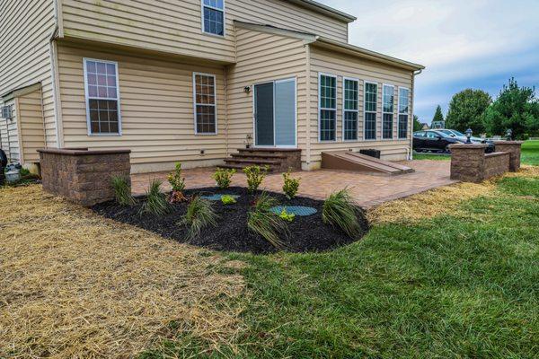 Paver patio with, steps, wall, columns and lighting installation.