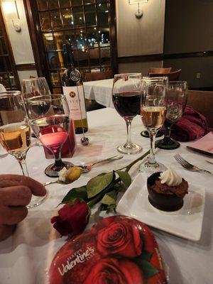 Champaign, a red rose and Valentine's Day chocolates.