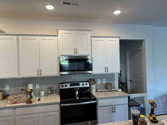 Installation of cabinets handles.