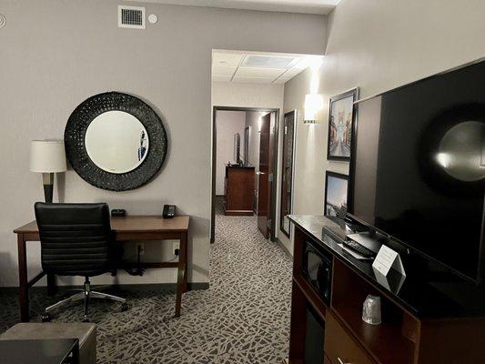 Living room-TV stand has small college size fridge & microwave