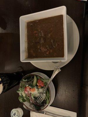 Hearty bowl of beef stew and a side salad, and a pint of Guinness.